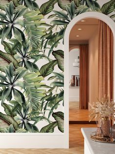 the wallpaper in this room is painted with tropical leaves