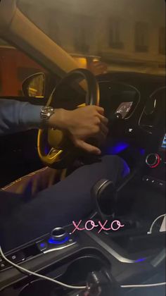 a person driving a car with their hands on the steering wheel