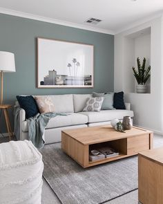 a living room with grey walls and white furniture