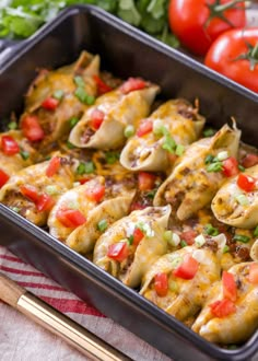 a casserole dish with tortilla shells and tomatoes