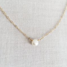 This is a single pearl necklace made of genuine high quality fresh water pearl. This fresh water pearl necklace is light weight and elegant. This tiny pearl necklace is around 5mm. This pearl necklace is great for layering with other gold necklaces. Pearl is June birthstone. Measurement: 5mm fresh water pearl S for Sparkle on Etsy https://www.etsy.com/shop/sforsparkleshop -------------------------------------------------------------------- S for Sparkle Mission We believe that everyone should ha Minimalist Pearl Drop Necklace With Round Beads, Delicate Chain Pearl Necklace, Minimalist Pearl White Round Bead Necklace, Minimalist Pearl White Necklace With Round Beads, Delicate Chain Pearl Necklace With Round Beads, Minimalist White Pearl Drop Necklace, Simple Pearl Clavicle Chain Necklaces, Simple Pearl Necklace With Clavicle Chain As Gift, Simple Pearl Clavicle Chain Necklace As Gift