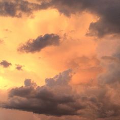 an airplane is flying in the cloudy sky