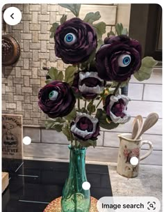 a vase filled with purple flowers on top of a counter