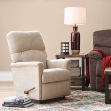 a living room with two recliners and a lamp