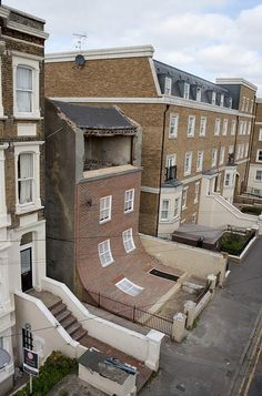 an aerial view of some buildings in the middle of a street with stairs leading up to them