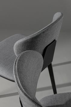 an upholstered chair is shown in black and grey tones, with the seat folded back