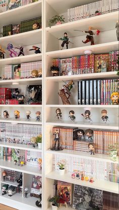 the shelves are filled with many books and figurines on top of each shelf