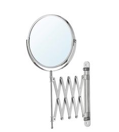 a magnifying mirror is hanging on the wall next to a metal rack with hooks