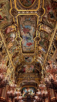 an ornate ceiling with paintings and chandeliers