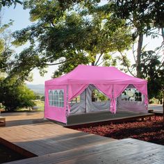 a pink tent sitting on top of a wooden platform