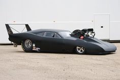 a black car parked in front of a white building