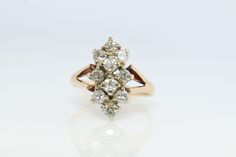 an antique diamond cluster ring in yellow gold