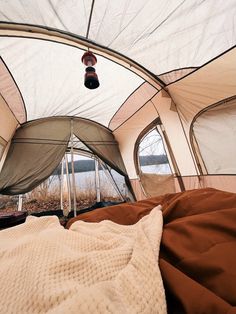 the inside of a tent that is set up for people to sleep in and relax