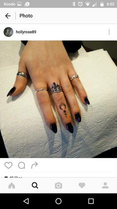 a woman's hand with two rings on it