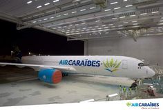 an air caradies airplane is parked in the hangar