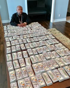 a man sitting at a table covered in money