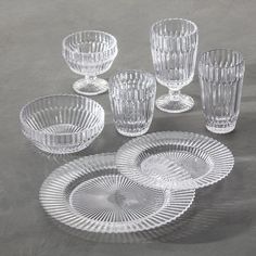 an assortment of clear glass dishes and glasses