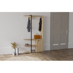 an empty room with a wooden shelf and coat rack