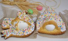 two decorated donuts with sprinkles and eggs in the shape of houses