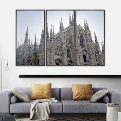 three pictures of the cathedrals in europe are hanging on a wall above a couch