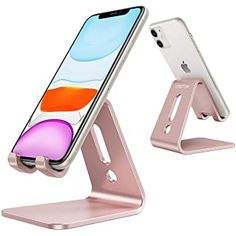 an iphone is sitting on top of a metal stand with one phone in it's holder