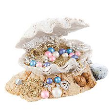 an animal figurine is sitting on top of a pile of sand and shells