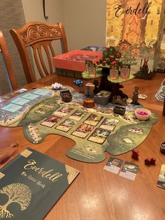 a wooden table topped with lots of cards and other items on top of the table