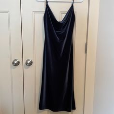 a black dress hanging on a white door