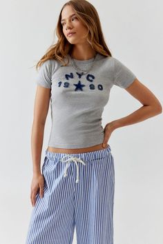 NYC 1990 Applique Baby Tee Urban Outfitters Baby Tee, Trendy Clothes 2024, Brandy Melville Baby Tee, Fitted Graphic Tee, Clothes For Christmas List, Baby Tee Designs, Birthday Wishlist Ideas I Want, Baby Tees Outfit, Brandy Melville Clothes