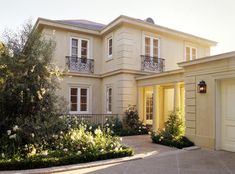 a large house with lots of windows and bushes