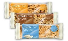 three bags of thinkthiin crunch are shown in this undated image, one is filled with nuts and the other contains peanut butter