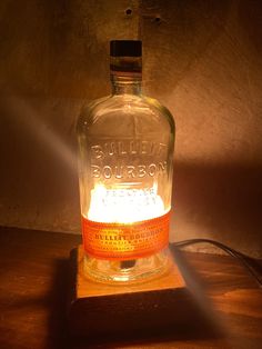 a bottle that is sitting on a table with a light coming from it's top