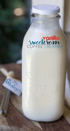 a bottle of yogurt sitting on top of a wooden table