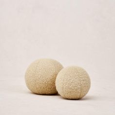 two white balls sitting next to each other