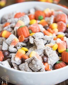 a white bowl filled with halloween muddy buddies