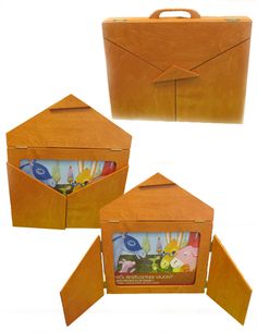 an open wooden box with two pictures inside