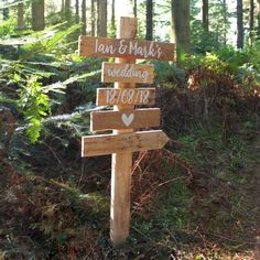 a wooden sign in the woods that says, i am & mark's wedding