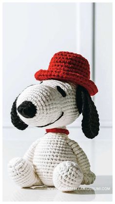 a crocheted dog wearing a red hat