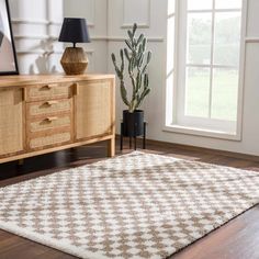 a living room scene with focus on the area rug and wooden sideboard against the wall