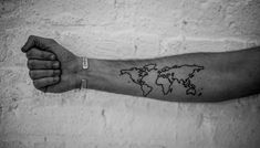 a man's arm with a world map tattoo on it