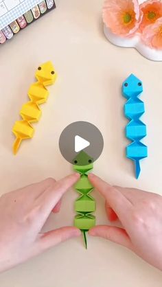 someone is making origami seahorses out of paper