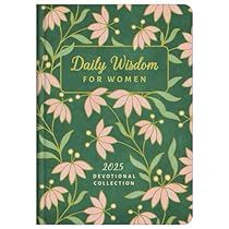 a green notebook with pink flowers and leaves on the cover, reads daily wisdom for women