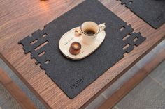 a cup of coffee sitting on top of a wooden table