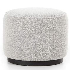 a white and black ottoman sitting on top of a floor