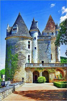 an old castle with turrets and hedges