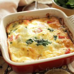 a casserole dish with spinach and cheese