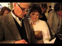 an older man and woman standing next to each other