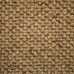 closeup view of the texture of a carpet with brown and tan colors on it