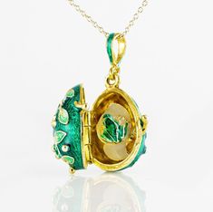 "Jewelry locket pendant with the frog surprise inside. Enameled and 24 K gold plated over solid sterling silver, this pendant is designed and made in our NJ shop in the tradition of Faberge jewelry. A green frog , in a color, matching the outside surface of the pendant, sits on white leaves, and is fixed steadily inside the locket. The egg is 20 mm (0.7\") long without a bail for a chain. It comes with 18' sterling silver gold plated chain and in a gift box. If you feel that you need a longer ch Black Locket, Bouquet Jewelry, Faberge Jewelry, Sterling Silver Locket, Green Pendants, Jewelry Lockets, Gold Pendant Jewelry, Green Frog, Art Nouveau Jewelry