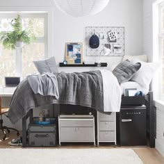 a bedroom with white walls and gray furniture